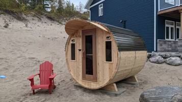 Relax in a serene beachside sauna, adjacent to a cozy seating area.