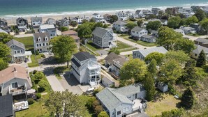 A coastal residential area with houses, a beach, and a clear view of the ocean. - 7-bedroom home that sleeps 14.  5-minute walk to Moody Beach (Wells)