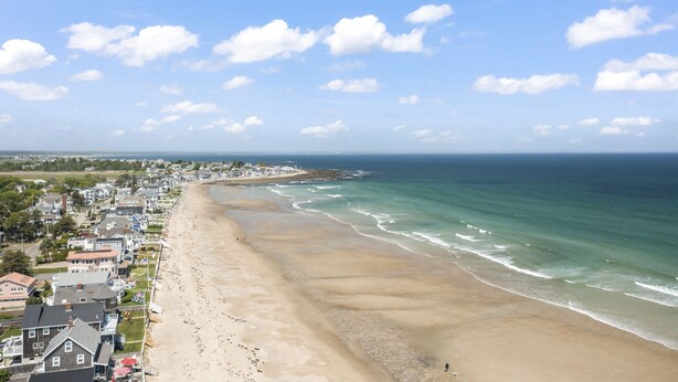 A coastal town with a beach, houses, and a clear sky. - 7-bedroom home that sleeps 14.  5-minute walk to Moody Beach (Wells)