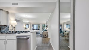 Una cocina moderna con una isla central, electrodomésticos integrados y un comedor con vistas.