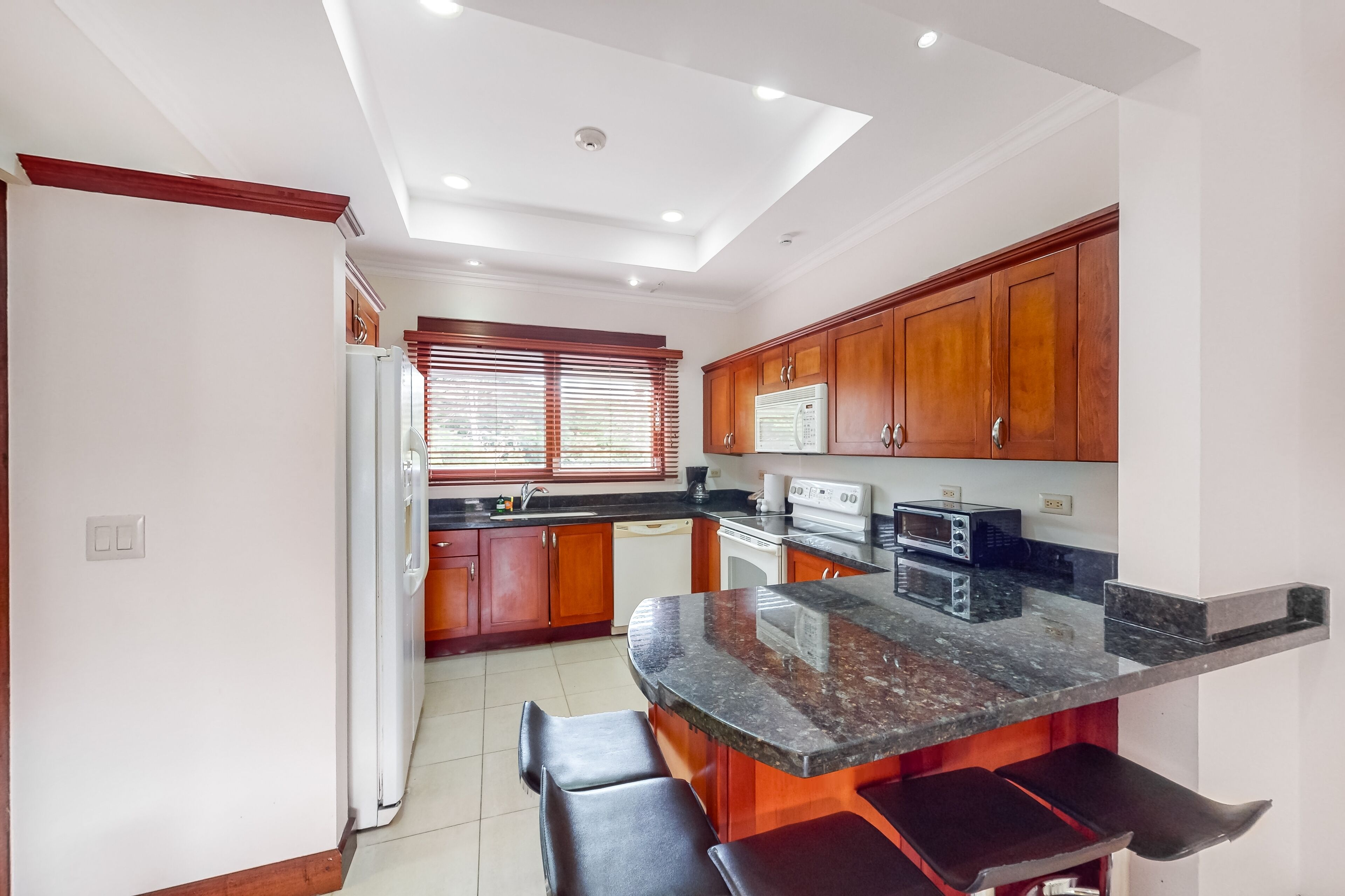 Tropical condo near the beach with shared pool, balcony, & W/D