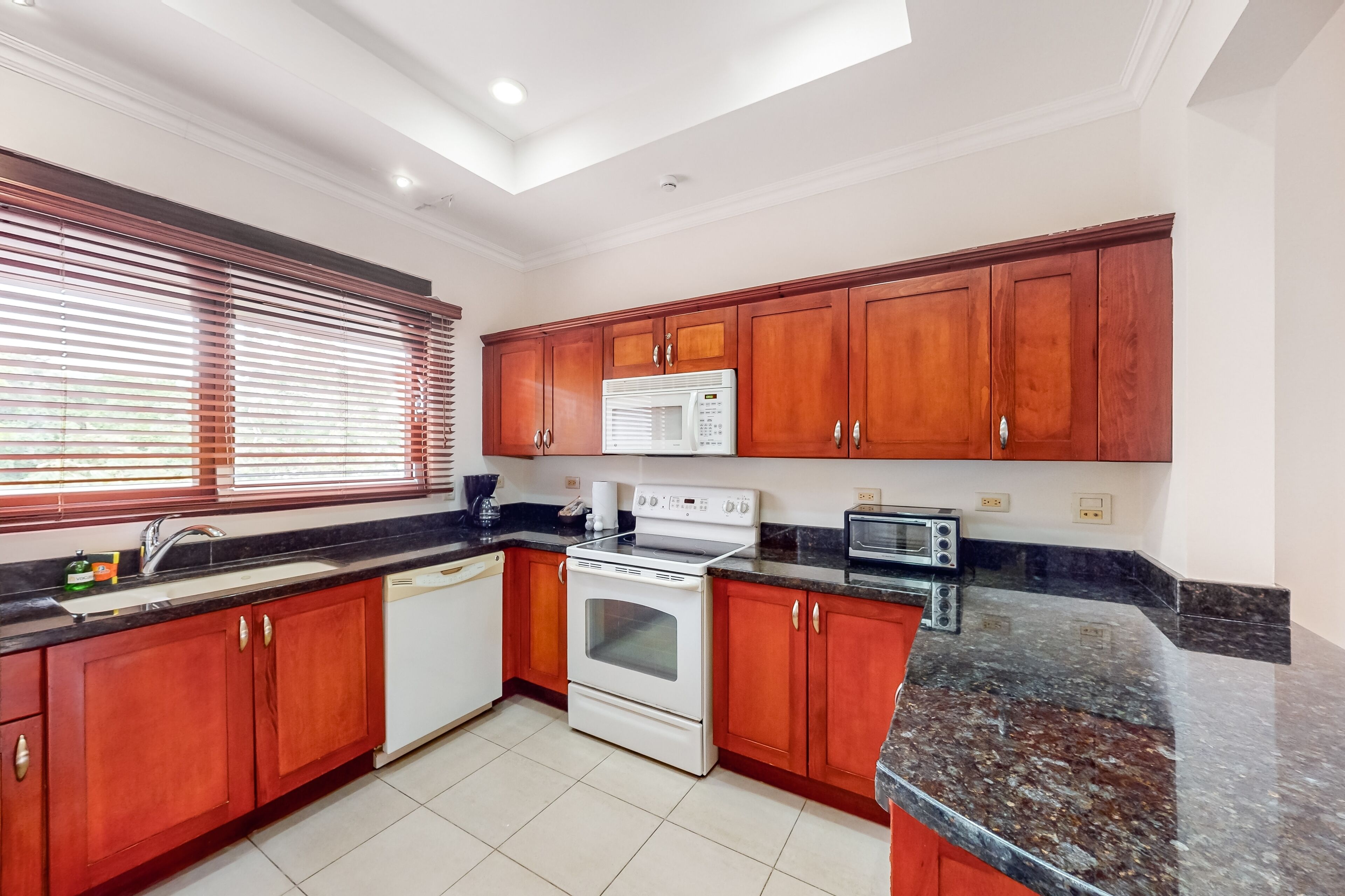 Tropical condo near the beach with shared pool, balcony, & W/D