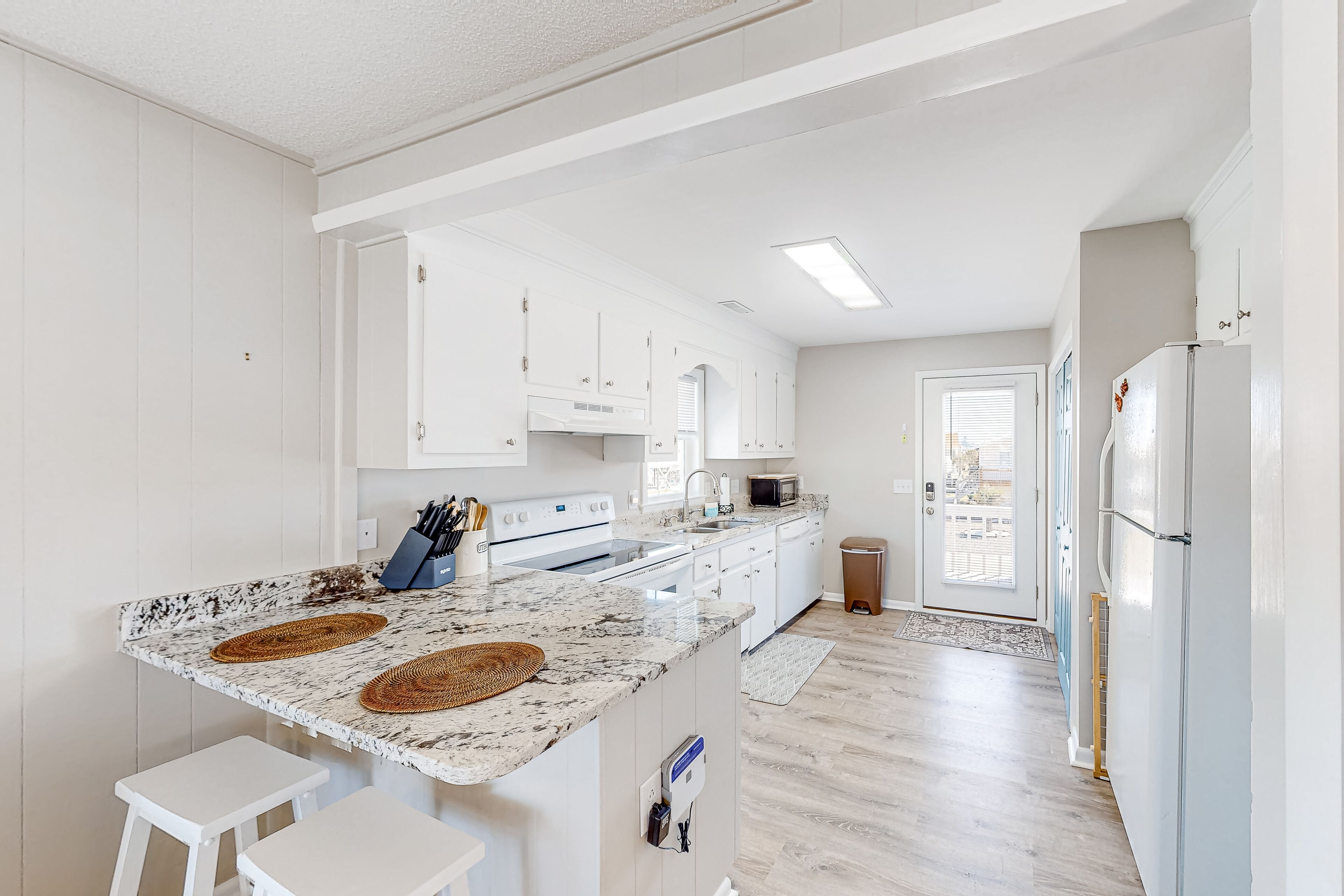 Canal-front dog-friendly home with beach views, dock, balconies, & beach access