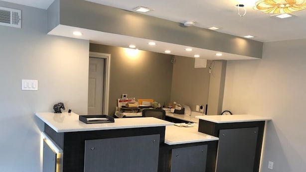 A modern bathroom with a central sink, a mirror, and recessed lighting. - Jackson motel  (Murfreesboro)