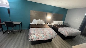 A hotel room with two beds, a desk, and a chair. - Jackson motel  (Murfreesboro)