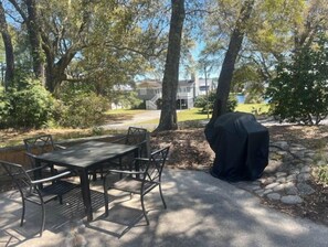 Enjoy al fresco dining on the patio surrounded by lush surroundings and a barbecue grill.