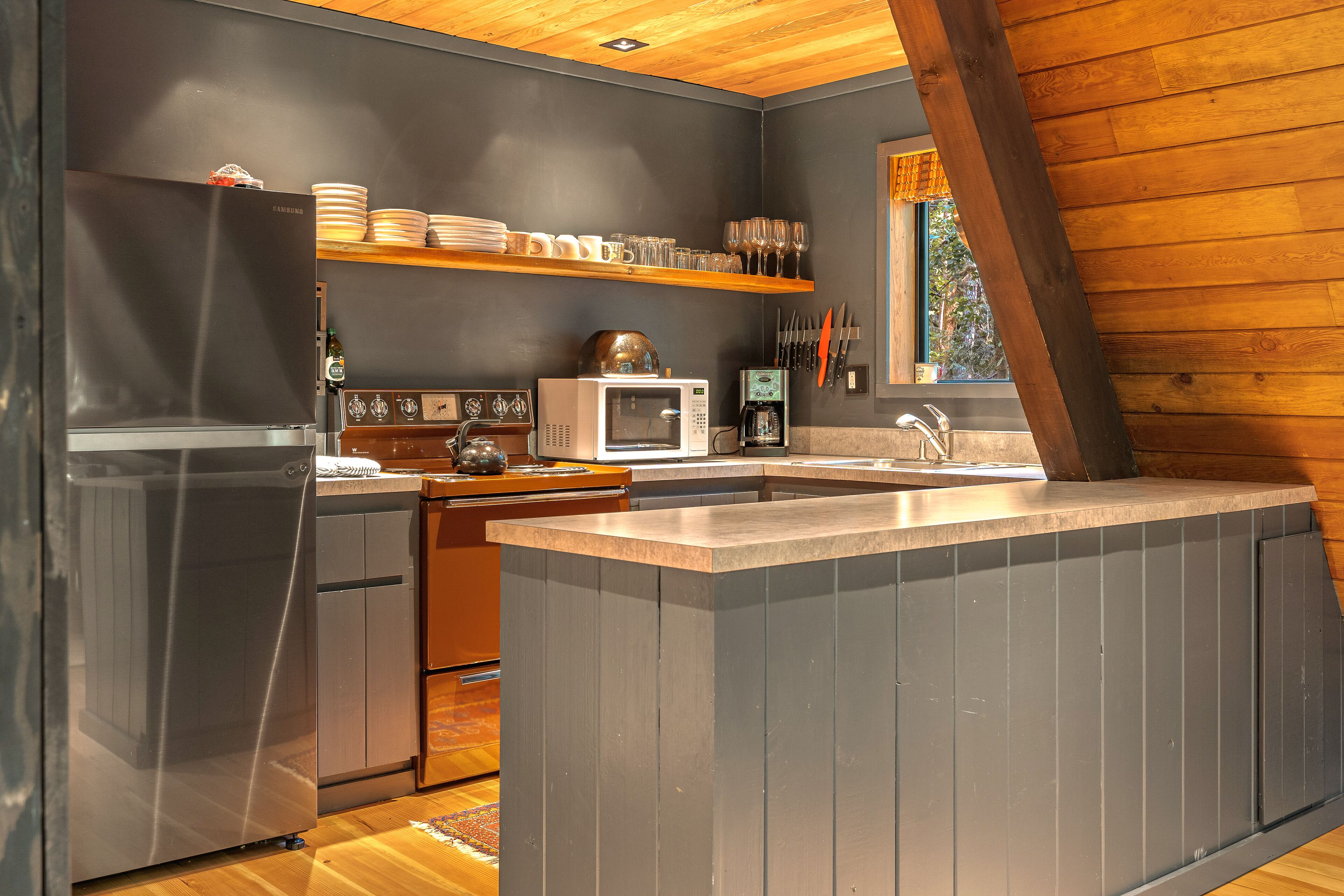 Riverside A-frame in gated cabin community with private deck, woodstove, & W/D