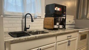 A kitchen with a sink, a coffee maker, and a toaster. - Divine Home Beach Retreat (Anavyssos)