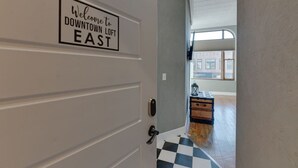 A door with a sign reading "Welcome to Downtown Loft East." - Downtown Spearfish Loft East (Spearfish)