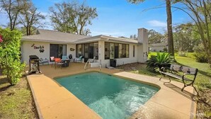 A house with a swimming pool, outdoor seating, and a covered patio. - Haven at Rainbow Springs: Kayaks, Pool, Game Room (Dunnellon)