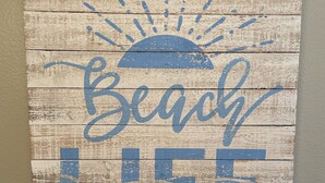 A wooden sign with the words "Beach Life" and a sun graphic.