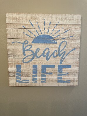 A wooden sign with the words "Beach Life" and a sun graphic.