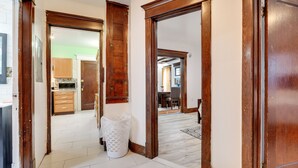 A hallway with wooden doors leading to a kitchen and a dining area. - Buffalo Vacation Rental ~ 20 Mi to Niagara Falls! (Buffalo)