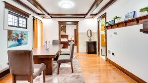 A dining area with a wooden table and chairs, a painting on the wall, and a fireplace. - Buffalo Vacation Rental ~ 20 Mi to Niagara Falls! (Buffalo)
