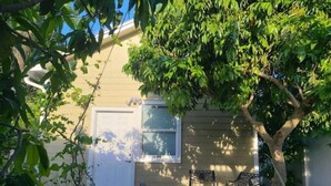 A house with a front door, a window, and two outdoor chairs. - Tropical Paradise studio #3 (Tampa)