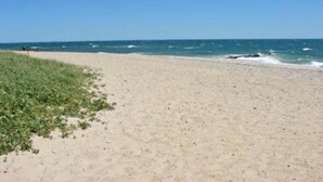 A beach with a clear sky and calm sea. - Private Falmouth home perfect for family fun - hot tub, fire pit, and game room! (Falmouth)
