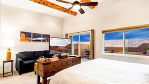 A bedroom with a bed, a desk, a chair, a TV, and a ceiling fan. - Gorgeous Moab Retreat with Red Rock and La Sal Mountain Views - South Valley (Moab)