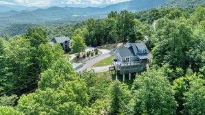 A house surrounded by dense forest with a clear road leading to it. - Brand new luxury home with a magnificent view , and luxurious hot-tub (Townsend)
