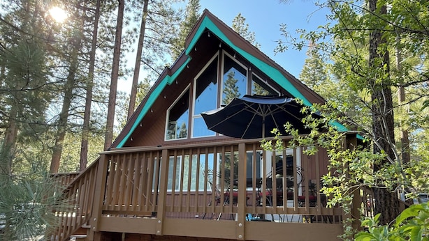 A cabin with a wooden deck, large windows, and a covered outdoor seating area. - Tahoe Time Cabin w/King Bed, Modern Tahoe Cabin w/ King Bed Suite & Level 1 EV Charging (Incline Village)