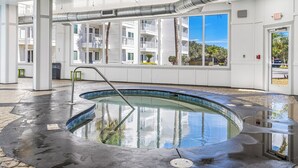 A swimming pool with a clear view of the surrounding building and a clear sky. - Beachfront Getaway at Gulf Shores Plantation! (Gulf Shores)