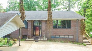A brick house with a front porch, a mailbox, and a staircase leading to the entrance. - Duskin Point Retreat - near Duskin Point Marina (Jasper)