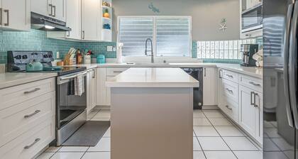 Two-story ocean view home with a furnished patio & deck, washer/dryer, & AC