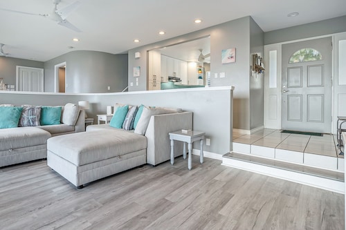 Two-story ocean view home with a furnished patio & deck, washer/dryer, & AC