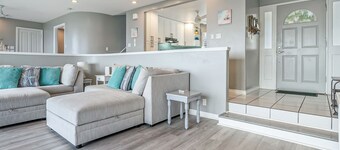 Two-story ocean view home with a furnished patio & deck, washer/dryer, & AC