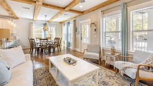 A spacious living area with a dining table, chairs, a sofa, and a coffee table. - Walk to Beach & Dining, Luxury Home in Seagrove, Private Pool, Sleeps 14, Bikes (Santa Rosa Beach)