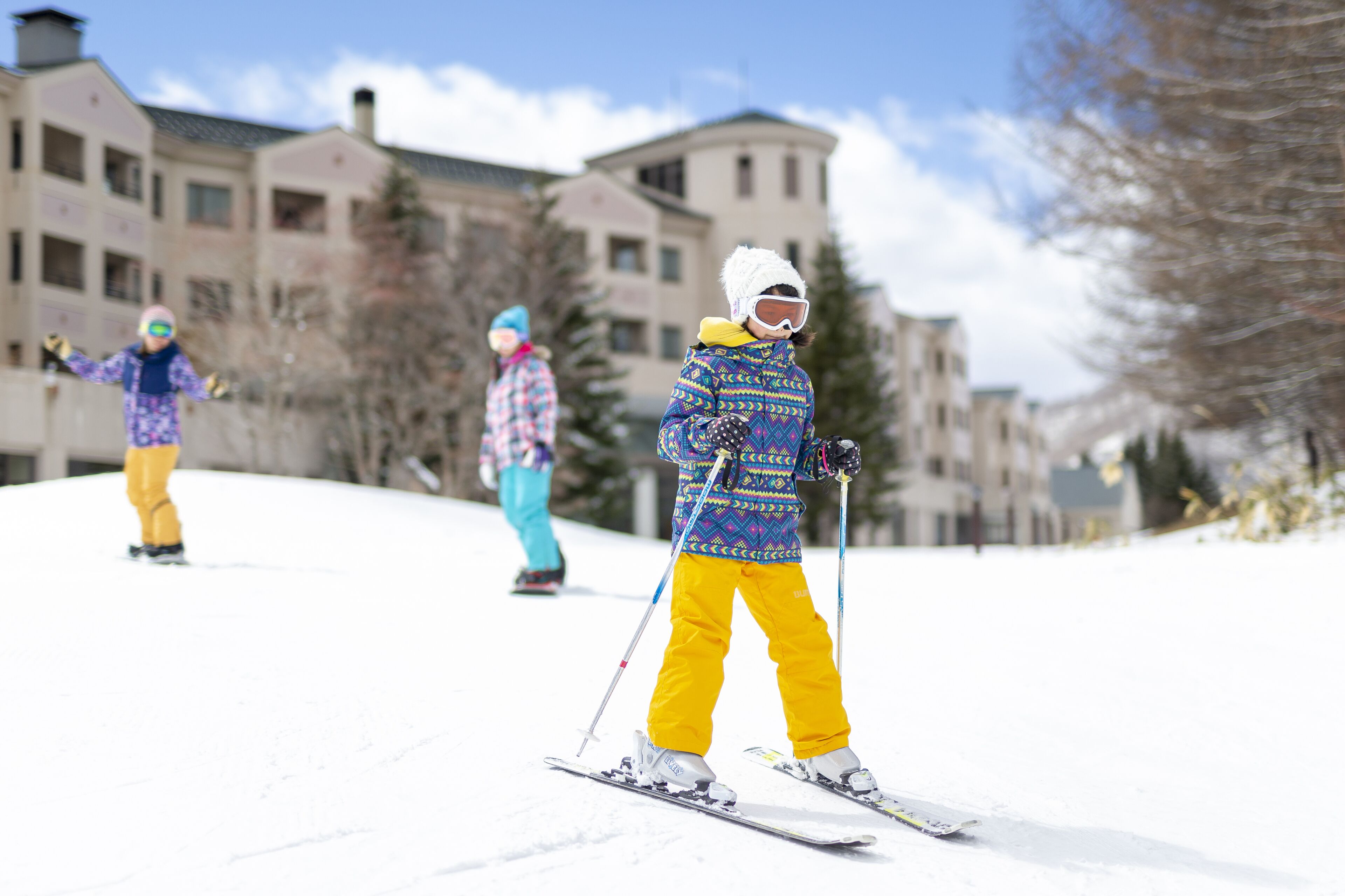 A ski resort with buildings and trees in the background.