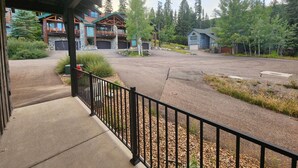A covered outdoor area with a paved walkway leading to a building with a stone facade and wooden beams. - Whitefish Mountain Escape, 6 Bedroom Sleeps 14, Amazing Views! (Whitefish)