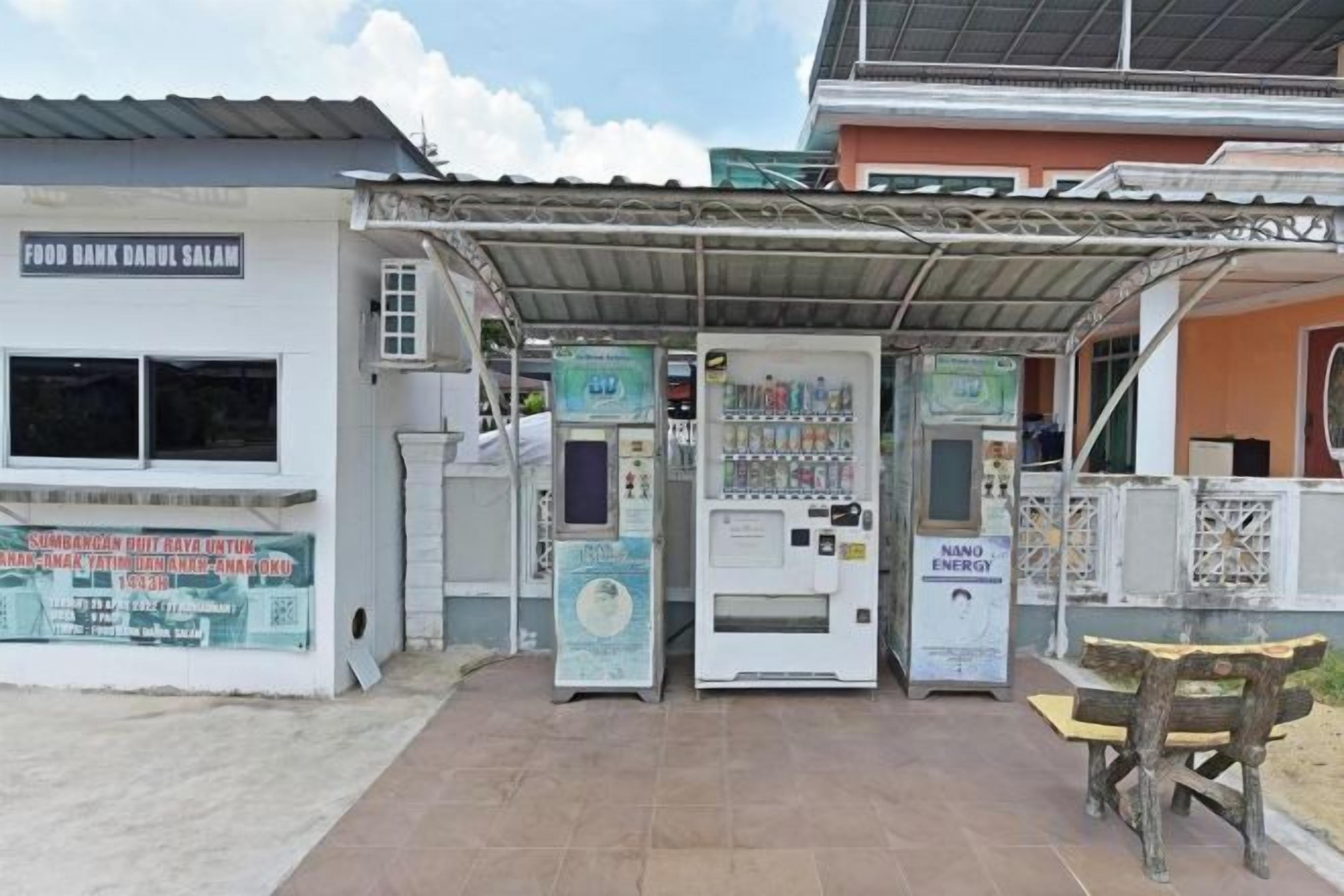 A food bank with vending machines and a sheltered seating area.