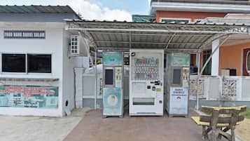 A food bank with vending machines and a sheltered seating area.