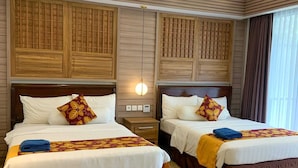 A hotel room with two beds, wooden headboards, and a modern ceiling design. - lorin beach resort belitung (Tanjung Pandan)