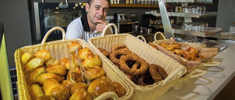 A bakery display with various baked goods in wicker baskets.