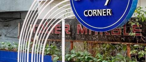 A sign for 'Hotel Kemps Corner' with a blue background and white lettering.
