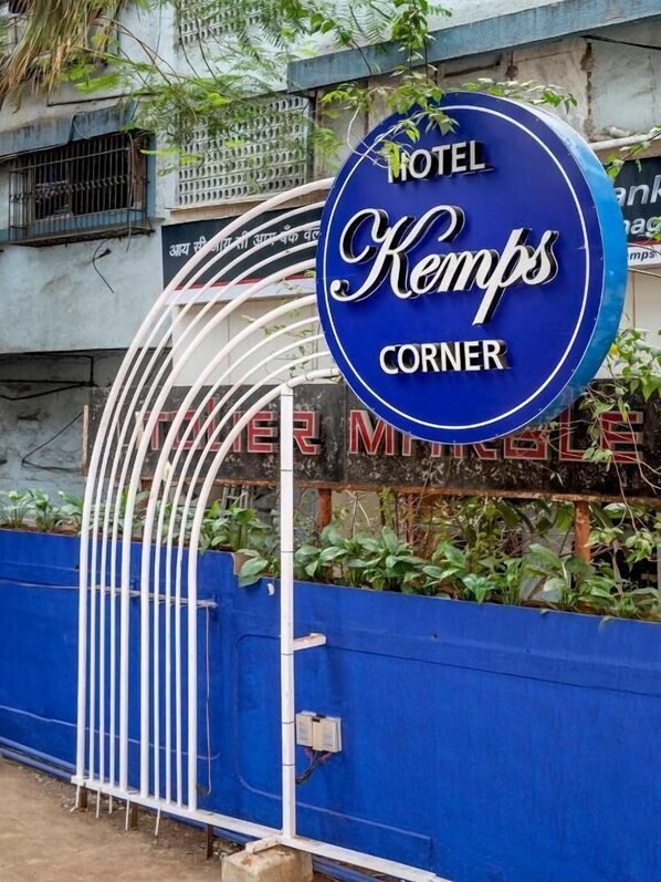 A sign for 'Hotel Kemps Corner' with a blue background and white lettering.