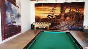 A pool table in a room with a large maritime-themed mural on the wall. - Maison de Campagne au Calme (Ventosa)