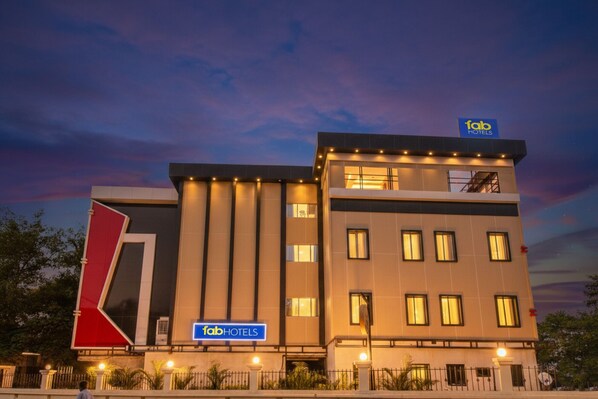 A modern hotel building with a prominent 'fab hotels' sign, multiple floors, and a well-lit facade. - Fabhotel Rk International (Mumbai)