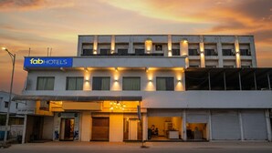 A modern hotel with a flat facade, multiple floors, and a sign indicating it is a FabHotels property. - FabHotel Devanshi Inn (Panvel)