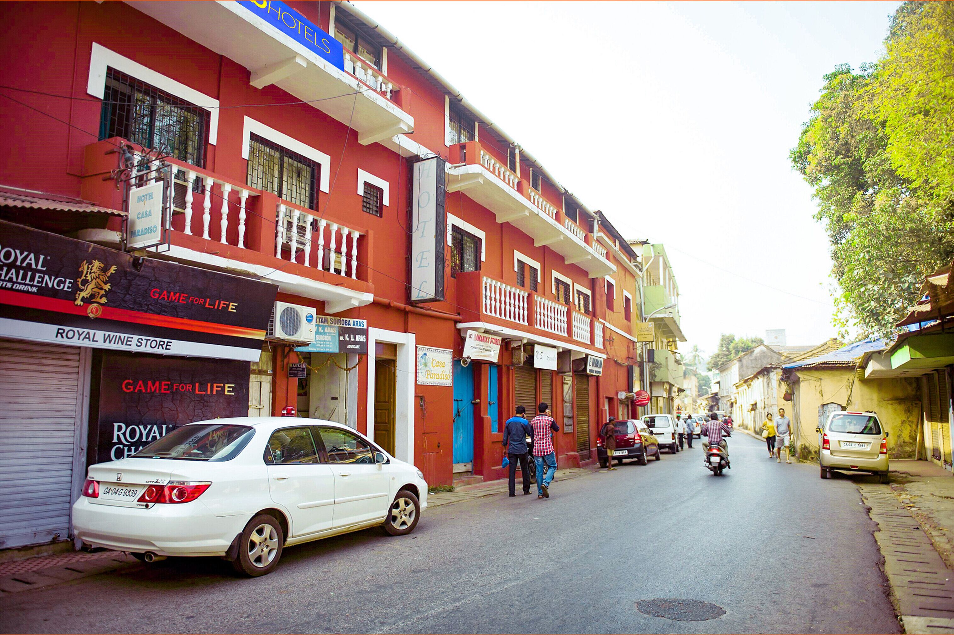 A street with a hotel named 'Hotel Casa Paradiso' and a Royal Wine Store.