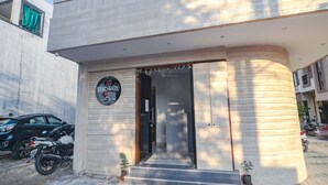A building entrance with a sign reading "BENCHMARK 4B". - Fabhotel Benchmark (Indore)