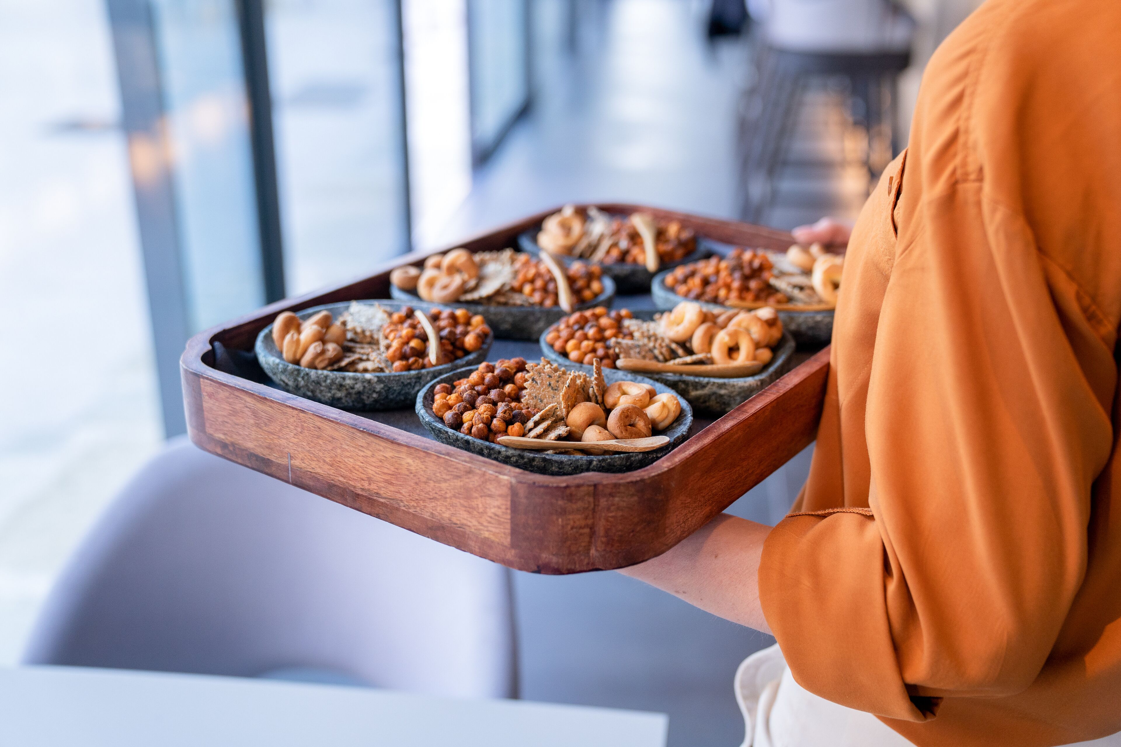 A tray with various baked goods and nuts.