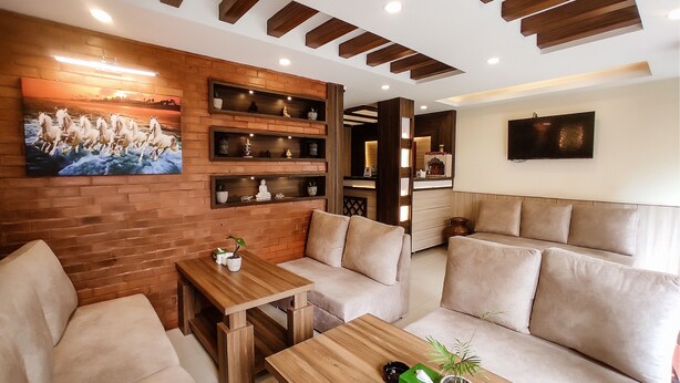 A cozy living area with a brick wall, wooden shelves, a sofa, and a coffee table. - Satkar Boutique Home (Kathmandu)
