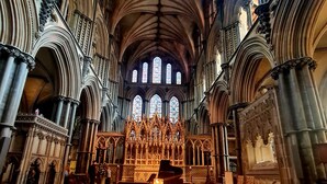 A cathedral interior with a checkered floor, rows of chairs, and a grand organ. - Oriental Garden Pod.  Set in our gorgeous garden of bonsai, pagoda and koi pond. (Swaffham)