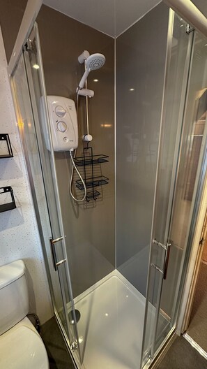 Shower, hair dryer, towels, toilet paper