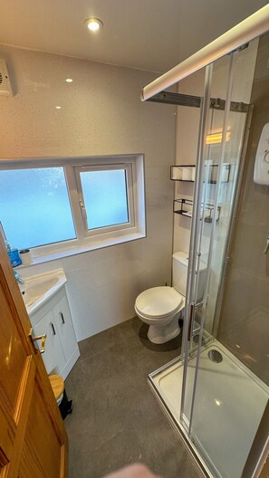 Shower, hair dryer, towels, toilet paper