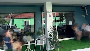 A hotel named "MONTANA HOTEL & HOSTEL" with a modern facade, a covered entrance, and a small Christmas tree decoration. - MONTANA Hotel & Hostel Phuket (Karon)