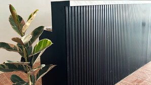 A potted plant with variegated leaves in a white pot, a black vertical panel, and a tiled floor with a geometric pattern. - MONTANA Hotel & Hostel Phuket (Karon)