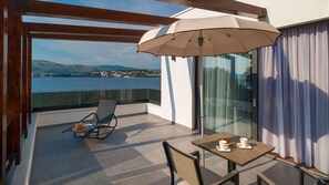 Relax on the balcony with a view of the water and distant landforms, where you can enjoy a meal or a drink in comfort.